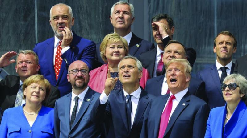 US President Donald Trump joins European leaders, including German Chancellor Angela Merkel, Nato secretary-general Jens Stoltenberg, Britains Prime Minister Theresa May, French President Emmanuel Macron, for a  family picture  ahead of the opening ceremony of the Nato summit in Brussels on Wednesday. (Photo: AP)