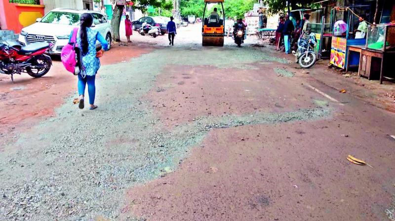 Pothole being filled with gravel in KPHB colony.  (Photo:DC)