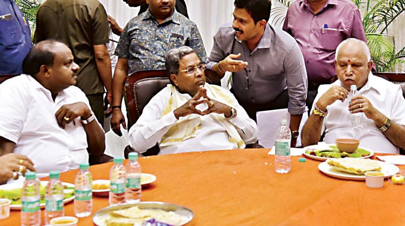 Chief Minister H.D. Kumaraswamy (from L) having lunch with former CM Siddaramaiah and BJP state chief B.S. Yeddyurappa in Vidhana Soudha on Thursday.