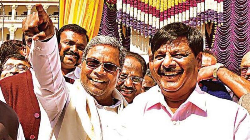 A file picture of former minister H.C. Mahadevappa with  former chief minister Siddaramaiah.