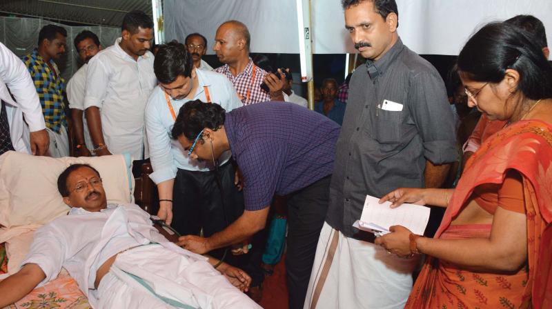 A doctor checks the health condition of BJP leader V. Muraleedharan in Thiruvananthapuram on Sunday. BJP general secretary K. Surendran is also seen