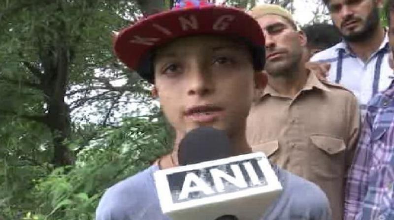 I want to be an officer like my father; I want to take revenge for his death. His sacrifice will bear fruit for Jammu and Kashmir, Ahmeds son Sahil said. (Photo: ANI)