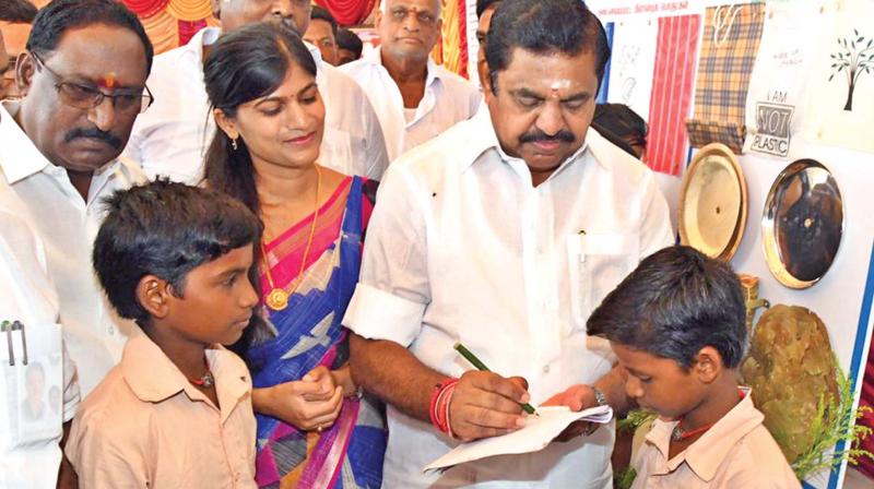 Chief Minister K. Palaniswami signing autograph for the school kids with a pen made of banana fibre during a government function to campaign against plastic use, at the Nehru stadium at Salem on Friday. Also present was District Collector Rohini Bhajibhakare, along with senior officials, MLAs and MPs.	 (Image: DC )