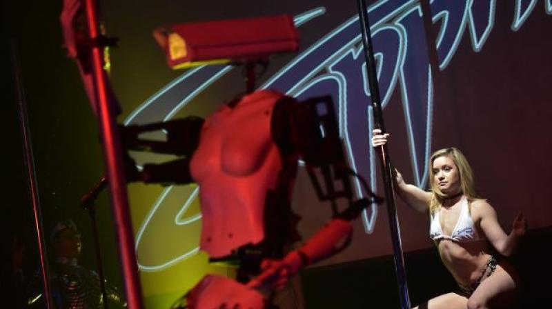 The robo-strippers are the creation of British artist Giles Walker, who said he designed the vaguely humanoid machines as an expression about surveillance, power and voyeurism. (Photo: AFP)
