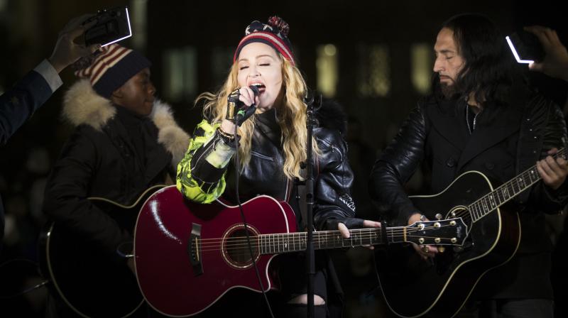 As she finished the concert, she urged the growing crowd to go to the polls and vote for Clinton. (Photo: AP)