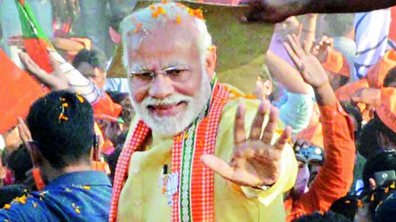PM Narendra Modi during a road show in Varanasi on Sunday.  He said whatever he got is due to the blessing of the people of Kashi. (Photo: PTI)