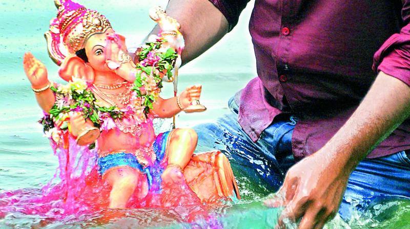 A Ganesh idol being immersed at the Tank Bund on the second day of Ganesh Chaturthi on Friday. (Image DC)