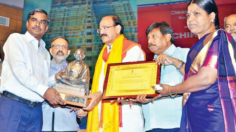Tiruchirapalli corporation commissioner Ravichandran , corporation engineer Nagesh and executive engineer S. Amuthavalli receive the cleanest city in South Zone award from union minister Venkaiah Naidu in New Delhi.