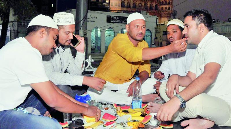 Muslims break fast on the first day of the month of Ramzan at Macca Masjid in Hyderabad on Thursday. 	(Image: P. Surendra)