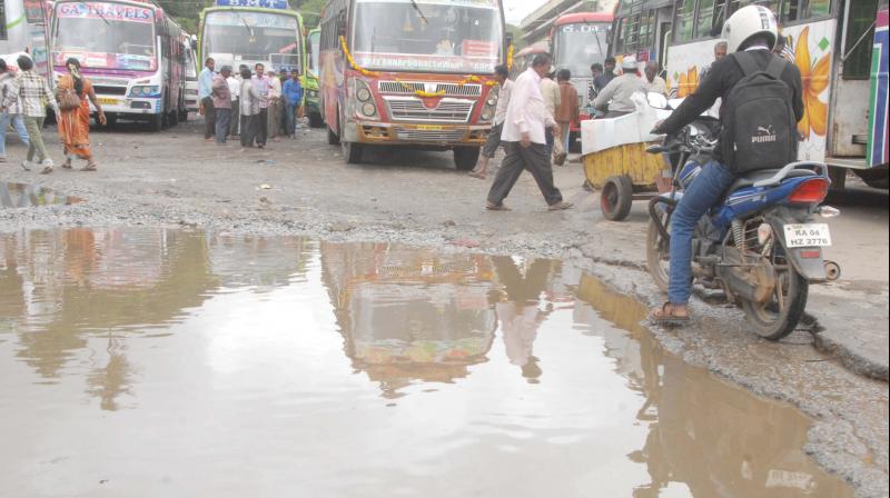 A file photo of a massive pothole at Kalasipalya bus stand in Bengaluru  (Image: DC)