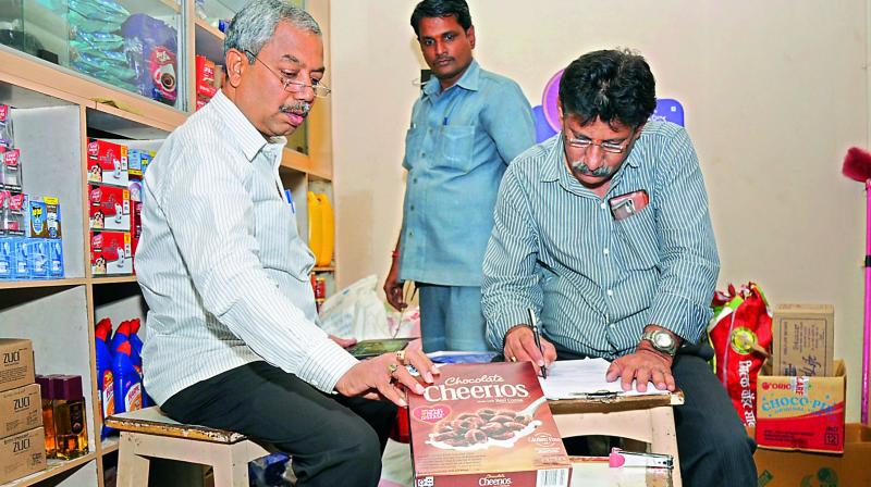 Officials from the food inspection department check items at the Balaji grand bazar on Friday (Photo: DC)