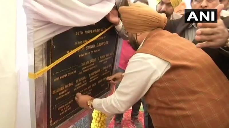 Punjabs Jails Minister Sukhjinder Singh Randhawa puts a black tape on his name and that of Chief Minister Captain Amarinder Singh. (Photo: ANI: Twitter)
