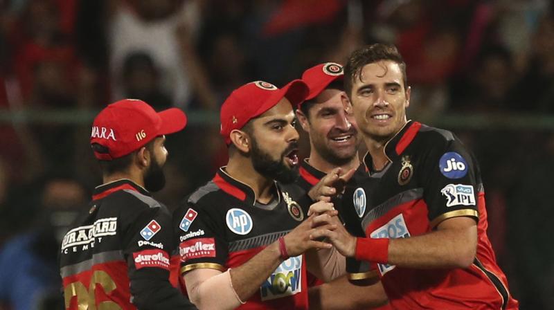 Tim Southee (2-25) and Mohammed Siraj (2-28) bowled brilliantly in the final overs and Umesh Yadav (2-29) picked up two early wickets to seal Royal Challengers Bangalores 14-run win against Mumbai Indians. (Photo: AP)