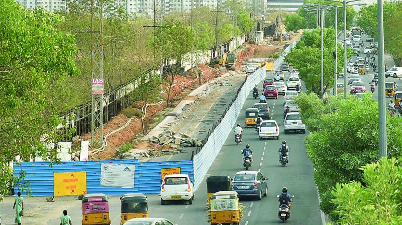 The road near Microsoft office in Gachibowli is dug up leaving just half of it usable for commuters. (Photo: DC)