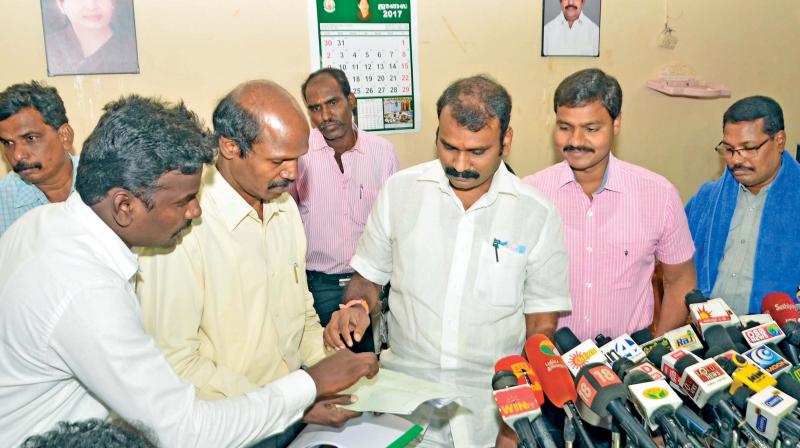 The National Commission for Scheduled Castes Vice Chairman L Murugan  is seen receiving petition from the Dalit family at the collectorate in Madurai on Saturday. (Photo: DC)