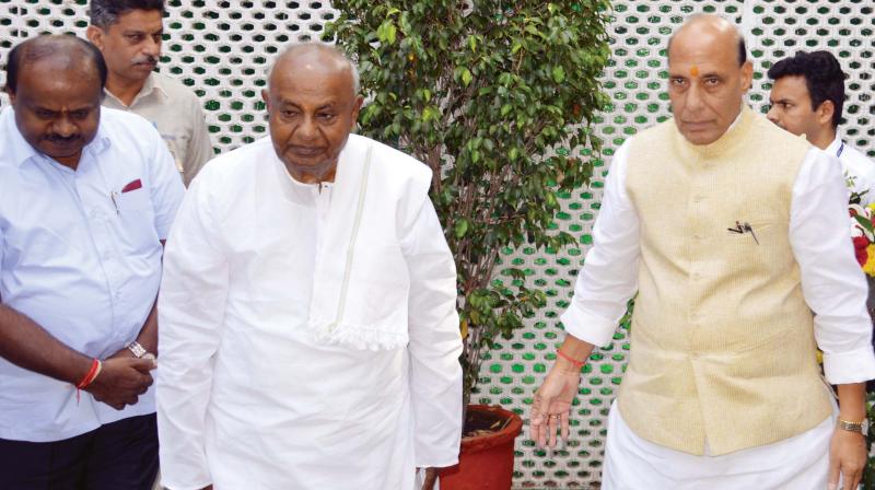 Union Home Minister Rajnath Singh with JD(S) supremo Deve Gowda and Chief Minister H.D. Kumaraswamy in New Delhi on Friday. Mr Gowda and his son called on Mr Singh to discuss various issues pertaining to the state.