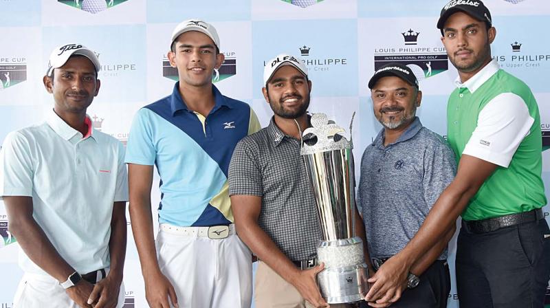 Participants pose with the Louis Philippe Cup trophy in Bengaluru on Monday.