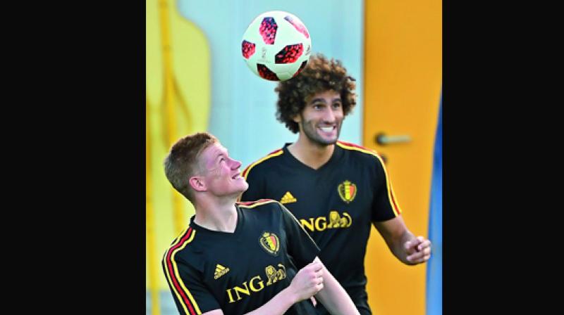 Kevin De Bruyne (left) of Belgium heads the ball next to teammate Marouane Fellaini during a training session. (Photo: AFP)