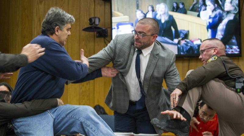 The enraged father of three daughters who were sexually abused by Larry Nassar lunged at the former USA Gymnastics national team doctor and tried to attack him during a sentencing hearing in a Michigan courtroom on Friday. (Photo: AP)