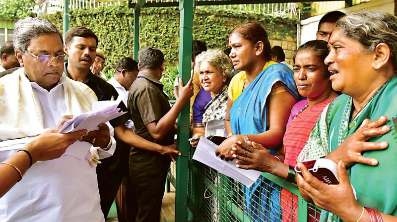 CM Siddaramaiah receives petitions during Janata darshan in Bengaluru on Thursday 	 KPN