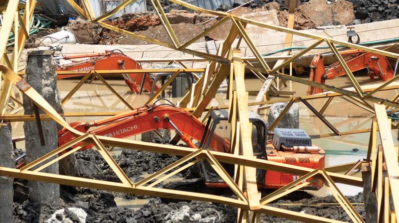 Construction machineries trapped under the collapsed building at Kaloor in Kochi 	DC FILE