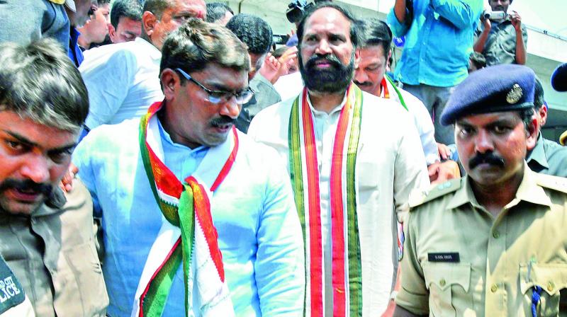 TPCC president N. Uttam Kumar Reddy is led away by police personnel after his arrest, at Ambedkar statue in Hyderabad on Monday. (Photo: DC)