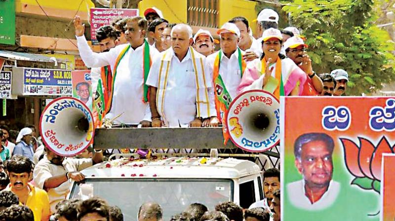 A file photo of State BJP president B.S. Yeddyurappa and party candidate Srinivasprasad campaigning in Nanjangud.