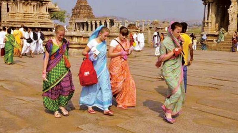 A file photo of foreigners clad in saris at Hampi.