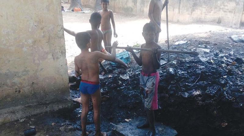 Students clear sewer blocks after being instructed by the hostel warden at a school in East Tambaram on Saturday. (Photo: DC)