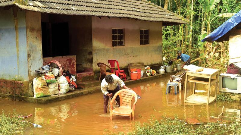 Flood survivors on a cleaning mission at their houses at Kannadikal in Kozhikode on Monday. (Photo: VENUGOPAL)