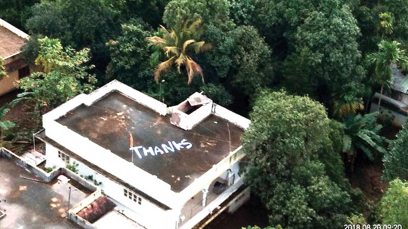 Mighty thanks for the angels from the rooftop: Thanks painted on an open terrace at Chengamanad near Aluva, where Navy squadron 321, nicknamed Gods Own Angels, winched to safety dozens, including a pregnant woman who delivered a healthy boy just 30 minutes from being rescued. The Navy, acknowledging its gratitude, released the picture on Monday, which has since gone viral.