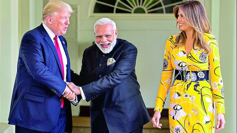 Prime Minister  Narendra Modi and US President Donald Trump share a joke as first lady of US Melania Trump looks on, at the White House, Washington DC, on Tuesday. (Photo: PTI)