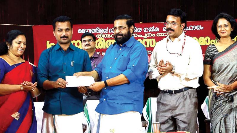 City mayor V.K. Prasanth hands over the money collected by the city corporation towards the relief fund to Tourism Minister Kadakampalli Surendran at a function in Thiruvananthapuram on Tuesday. Deputy mayor Rakhee Ravikumar, K.R. Jyothilal and district collector K.Vasuki look on.