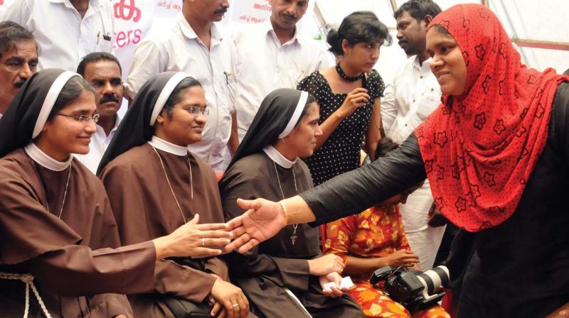 A Muslim woman greets nuns staging a protest at High Court Junction in Kochi on Tuesday seeking the arrest of Jalandhar Bishop Franco Mulakkal accused of raping a nun. (Photo: ARUN CHANDRABOSE)