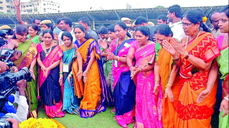 TRS MP K. Kavitha dances along with other women during Bathukamma celebrations at the LB Stadium on Tuesday.  (Photo: P. Anil)