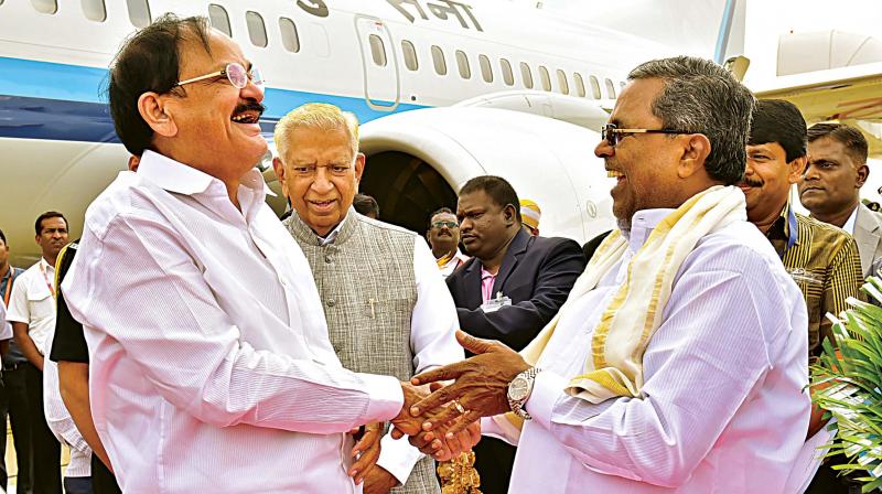 Governor Vajubhai Vala and Chief Minister Siddaramaiah welcome Vice-President Venkaiah Naidu at HAL Airport in Bengaluru on Tuesday