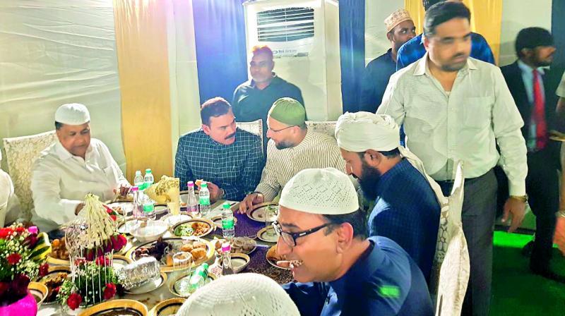 MIM chief Asaduddin Owaisi (centre) shares a dining table with MBT leader Amjedullah Khan (first from right), Hyderabad police commissioner Anjani Kumar (second from left) and others at an Iftar party, Chowmahalla Palace, on Thursday.