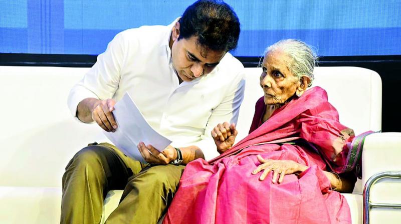 Minister K. T. Rama Rao listens to a 85-year old woman at â€œMana Nagaramâ€ event in Kukatpally on Friday.