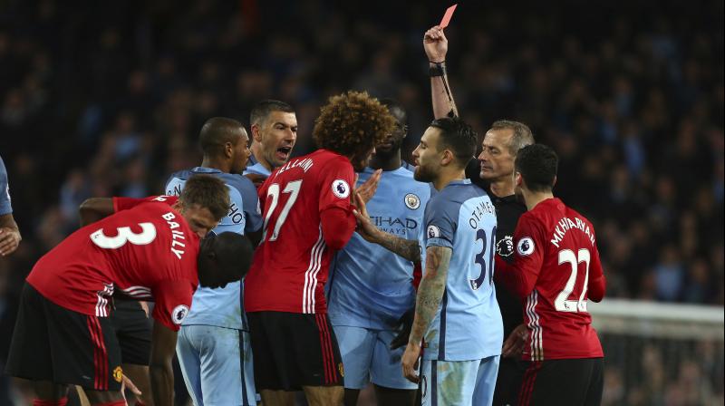 Booked for tripping Sergio Aguero in the 85th minute, Marouane Fellaini fouled him again seconds later and then blatantly butted the Argentinian, leaving referee Martin Atkinson no option but to send the Belgian off. (Photo: AP)
