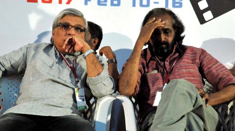 Kerala Chalachitra Akademi chairman Kamal and FFSI secretary V.K. Joseph listening to a song paying homage to late lyricist/screenwriter Gireesh Puthencherry on the occasion of his death anniversary, during the opening ceremony of 3rd edition of Kozhikode International Film Festival at Tagore Centenary Hall, Kozhikode on Friday.	(Photo: Venugopal)