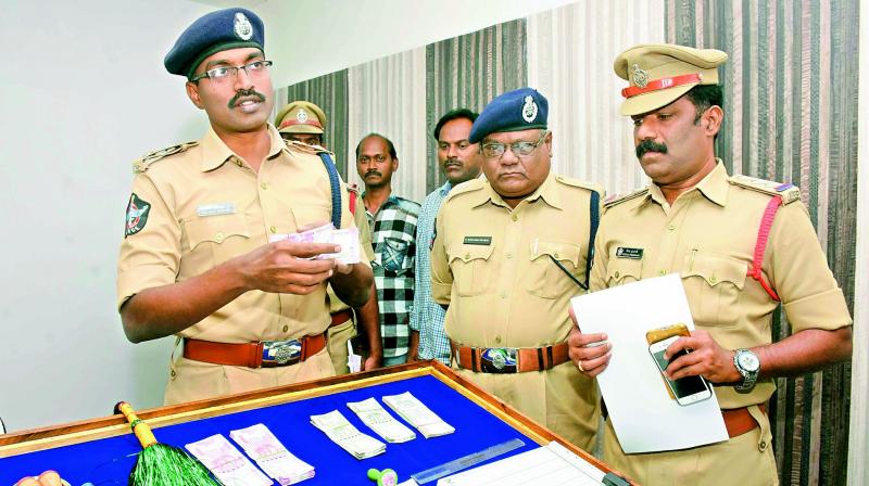 Kurnool SP A. Ravikrishna with the fake currency seized in Kurnool on Monday. 	(Photo: DC)