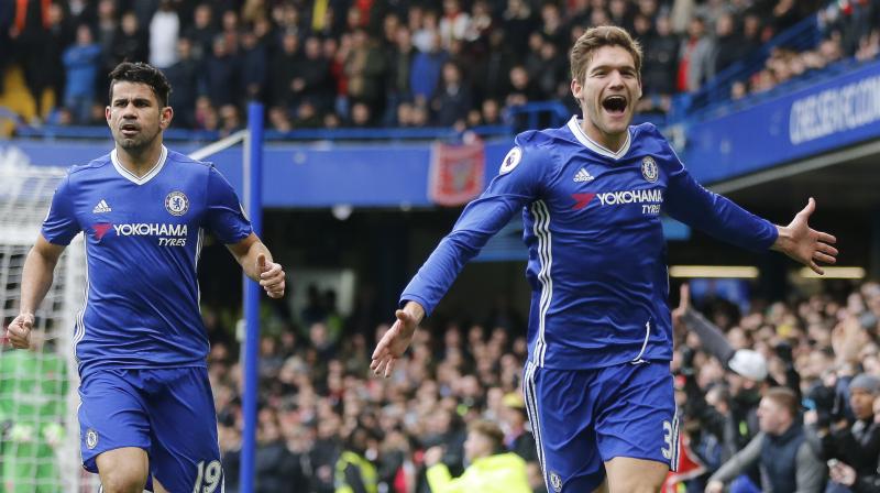Chelseas Marcos Alonso (R) celebrates after scoring against Arsenal. (Photo: AP)
