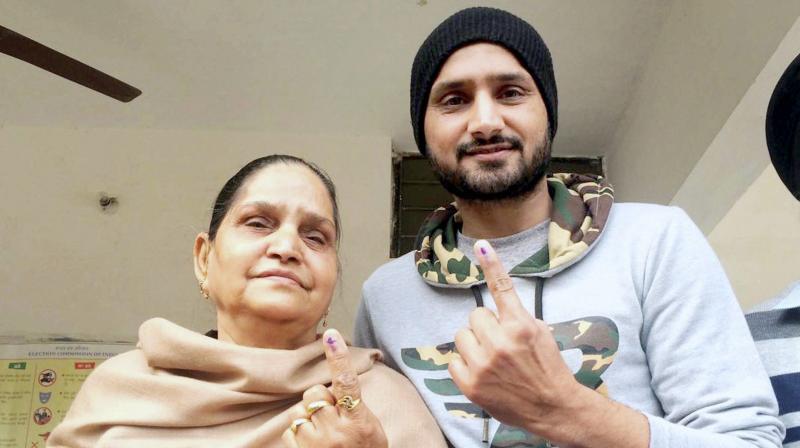 Harbhajan Singh and his mother after casting their votes at a polling station in Jalandhar. (Photo: PTI)