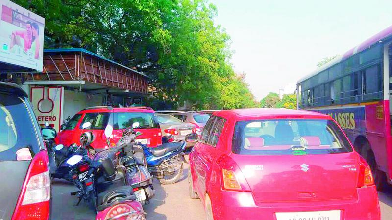 Vehicles parking in front of a bus stop at Sanathnagar on Wednesday. (Photo: DC)