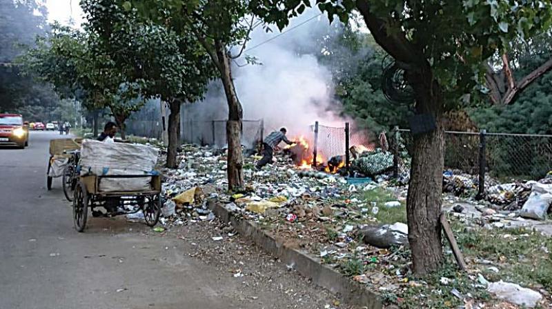 A garbage pile set on fire in Kasthuri Nagar.