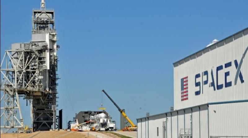 Space Xs Falcon 9 rocket is prepared for launch to the International Space Station at the Kennedy Space Center, on renovated Space Shuttle launch pads
