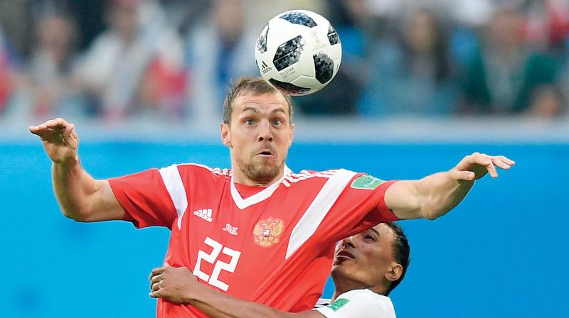 Russias forward Artem Dzyuba (left) and Egypts defender Mohamed Abdel-Shafy fight for the ball during a World Cup match at St Petersburg on Tuesday. Russia won 3-1. (Photo:AFP)
