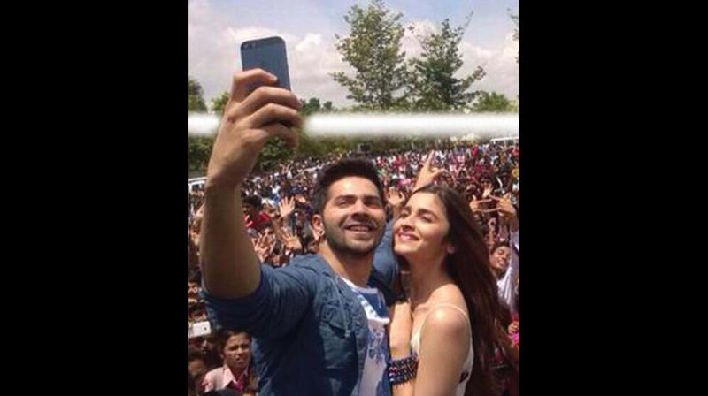 Varun Dhawan and Alia Bhatt take a selfie at an event held earlier in the city.