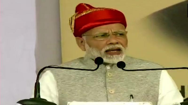 PM Modi launched four-laning of Solapur-Osmanabad section of NH-211, underground sewerage system and three sewage treatment plants and laid the foundation stone of 30,000 houses under Pradhan Mantri Awas Yojana. (Photo: ANI | Twitter)