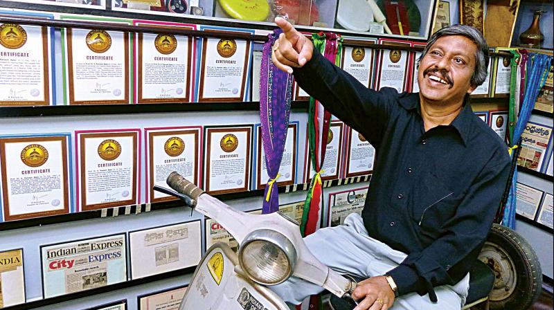 Ramesh Babu with his certificates